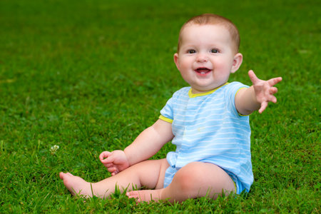 Summer portrait of happy baby boy infant outdoors at parkの写真素材