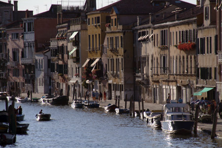 Waterfront diners enjoy the early evening in veniceの写真素材