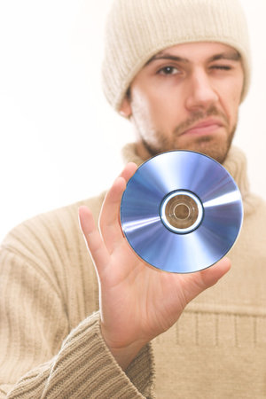Man with hat holding CD. The colors and focus make you look at the CD itself. Space for textの写真素材