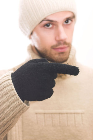 Man with hat pointing to the right. Focus on hand pointing. Photo can be flipped for 'pointing to the left direction' effect. Space for textの写真素材