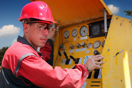 Oil and gas well drilling worker operate drilling rig machinery  Selective focus 