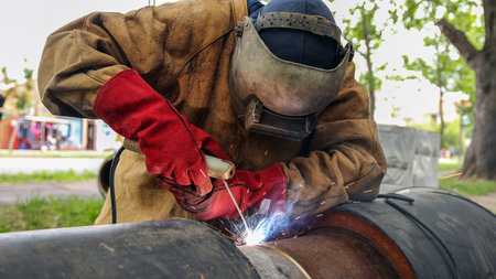 Welder With Protective Equipment Welding Outdoors