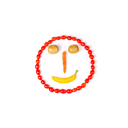 This smiley is made wirh carrot,kiwi,cherry tomatoes and bananaの写真素材