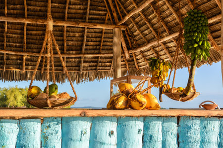 In the picture beach bar in Nungwi ( Zanzibar ) at sunset , with exposed coconut , banana and tropical fruit .This bar is made with cane bamboo,wooden and straw rope.の写真素材