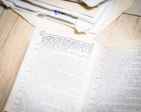 In the picture an open book where the word love is highlighted and its synonyms , the background of the letters .の写真素材