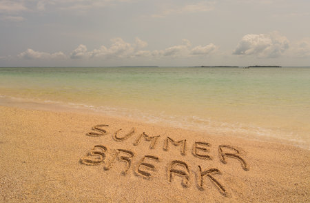 In the photo a beach in Zanzibar in the afternoon where there is an inscription on the sand "Summer Break".の写真素材