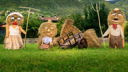 Lovely farmers family  Puppets(straw dolls) made out of Hay Bale with typical peasant clothes in europe autumn,square photo.の写真素材