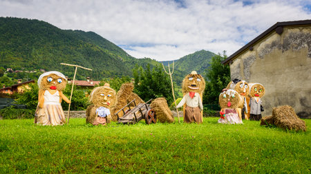 Typical big farmers family, Puppets(straw dolls) made out of Hay Bale with traditional peasant clothes in europe autumn.の写真素材