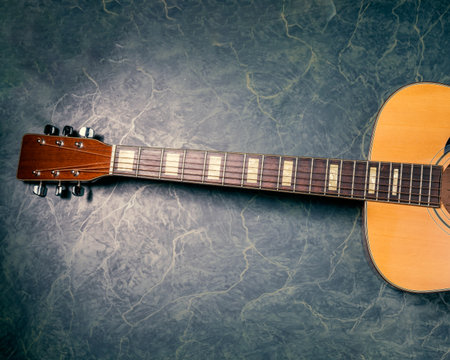 acoustic guitar on green,blue marble background,music concept.
