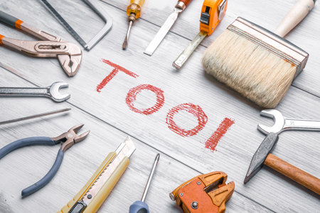 Set of work tools on rustic wooden background with written