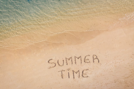 aerial view of the inscription on the sand Summer Time, Caribbean beach and ocean seen from above