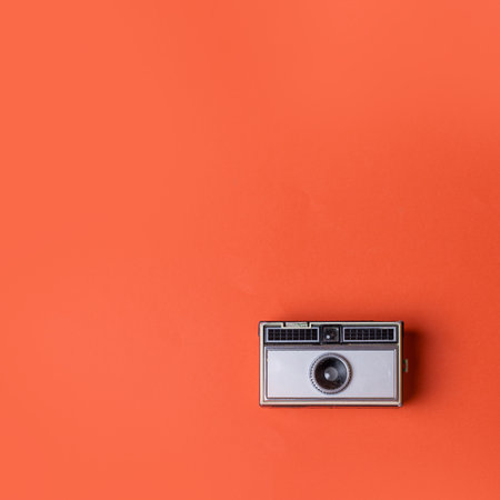 Old vintage Photo Camera on a orange Backgroundの写真素材