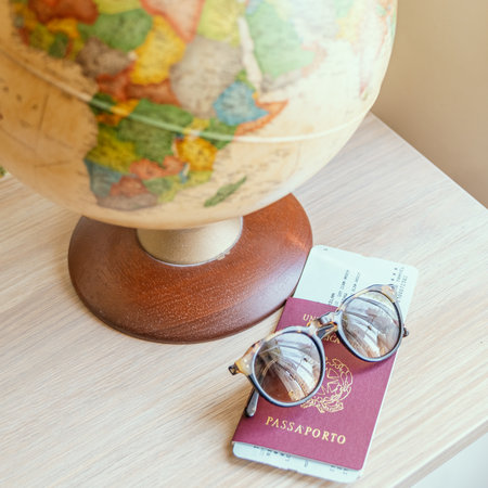 globe,sun glasses,ticket airplane and passport on a wooden table. Idea, photo tourism, adventure, travel around the worldの写真素材