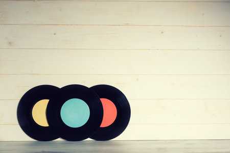 Vinyl records on wooden background, vintage styleの写真素材