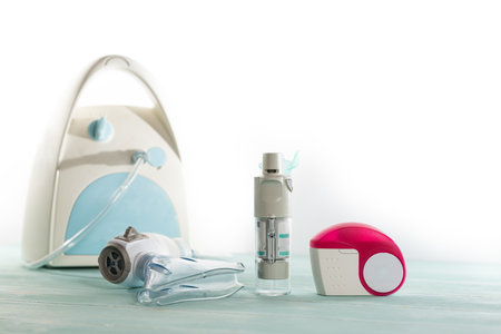 Set of asthma inhaler and aerosol machine with inhaler mask, concept asthma and treatment on green...