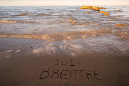 Aerial shot of sandy beach with umbrellas, typical adriatic shore.Summer vacation concept.Lido Adriano town, Adriatic coast, Emilia Romagna, Italy.の写真素材