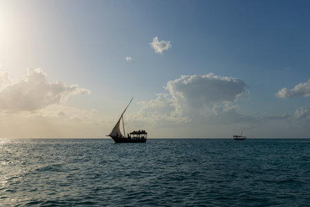 Silhouette of Dhow boat at sunny day, Indian ocean, Zanzibar in Tanzania.の写真素材