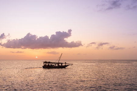 Dhow boat at sunset, background clouds, Zanzibar, Tanzania.の写真素材