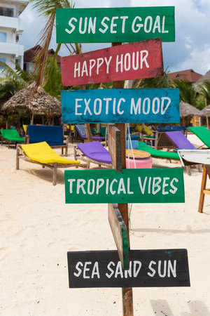 Colorful signs with the writing sun set goal,Happy hour,exotic mood,tropical vibes,sea sand sun, on sandy beach at sunny day,relax and summer concept.の写真素材
