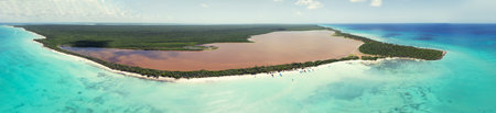 Panorama of all Saona Island. Caribbean Sea with clear blue sea, sandy beach and green palms....