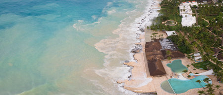 Dominican Republic, Panorama of dominicus beach at morning, Caribbean sea with big waves, palm tree, luxury resort and beautiful sandy beach, Bayahibe.の写真素材