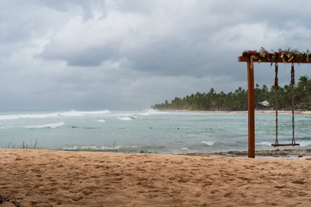 Dominican Republic Bayahibe beach at storm day, Wonderful waves sea with sandy beach and palm tree.Rainy day.の写真素材
