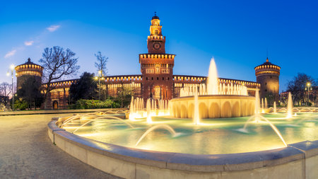 Sforza castle (Castello Sforzesco) at night, amazing old medieval Italian castle with fountain illuminated, Milan, Italy.の写真素材