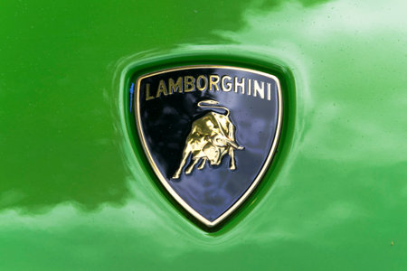 TURIN, ITALY - JUNE 13, 2015: Close-up of the classic Lamborghini logo, on the green body of a Huracan modelのeditorial素材