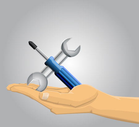 Hand holding a screwdriver and a wrenchのイラスト素材