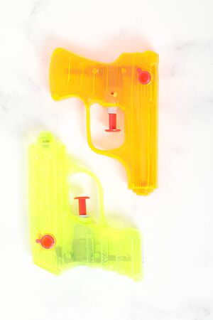 colored water pistol green on white background isolated