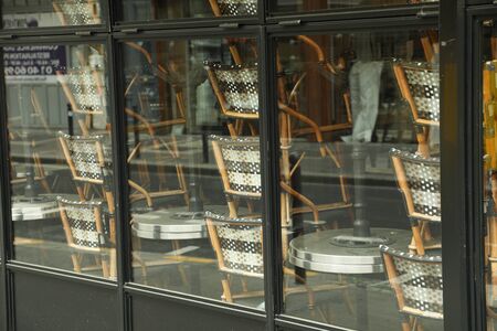 Rattan chairs stacked outside a bistro Franceの写真素材