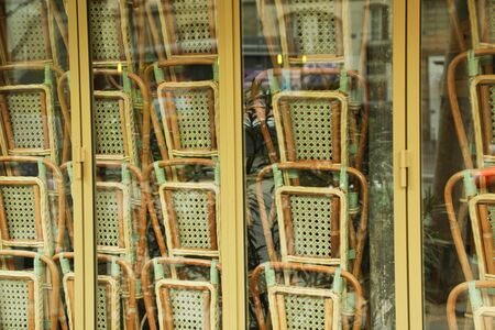 Rattan chairs stacked outside a bistro France