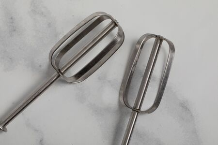Silver Eggbeater isolated on white marble ground