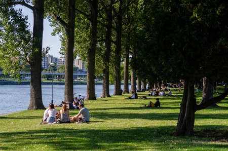 LIEGE, BELGIUM - AUGUST 22 2019: People sitting in the Boverie park during the summerのeditorial素材