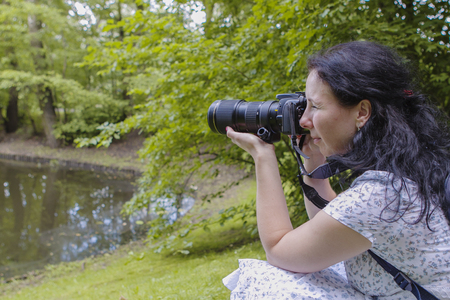 Photographer while taking a photoの写真素材