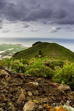 Green mountain pass during overcast dayの写真素材
