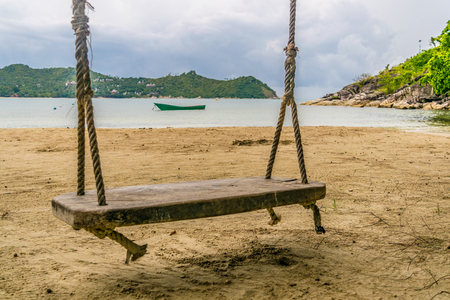 Swing with boat beach Koh Phanganの写真素材