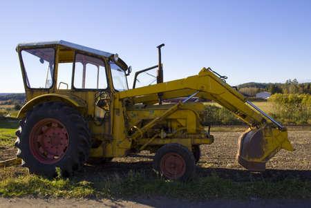 As we make better and more advanced machines the old ones are left to wither. This tractor seems to have seen its better days.の写真素材