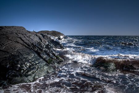 A clear blue sky overlooking the waves and hills of MÃ¸len in Vestfold.の写真素材