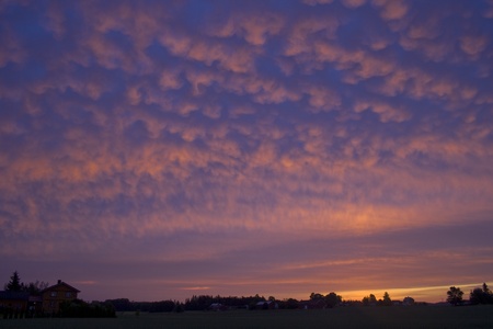 Late at night the sun is about to get up, and the clouds are marvellous to watch. The play of colors was very vivid.の写真素材