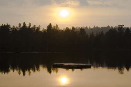 At the end of summer the light is smooth and the wind is calm. The floating pier in the water give me a sensation that civilization is not too far away though.の写真素材