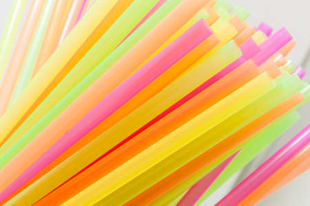 Colorful plastic straws used for drinking soft drinks, fresh juices, smoothies which are using in hotels and restaurants.の写真素材