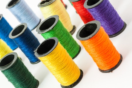 Colorful bobbin threads arranged in up right position using for embroidery worksの写真素材