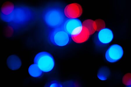 Blurred spots of blue and red lights bokeh for abstract color backgroundの写真素材