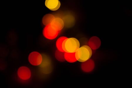 Blurred spots of yellow and red lights bokeh for abstract color backgroundの写真素材