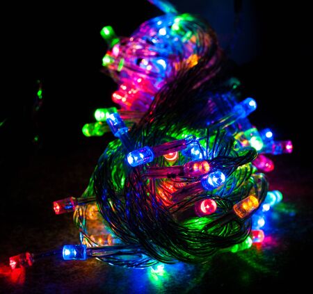 Red, blue, green and orange colored led christmas lights in nightの写真素材