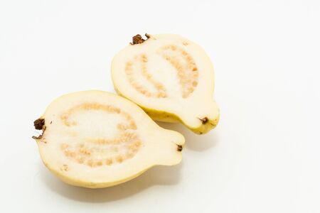 Guava fruit cut into two pieces on white backgroundの写真素材