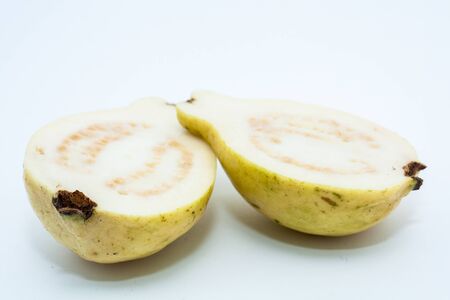 Guava fruit cut into two pieces on white backgroundの写真素材