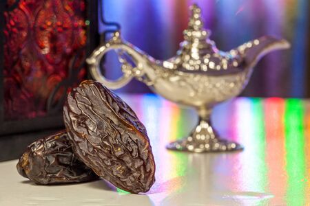 Date fruits,Aladdin's lamp and arabic lantern. Ramadan Eid background conceptの写真素材