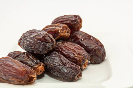 Date fruits in white plate . Ramadan, Eid background concept.の写真素材